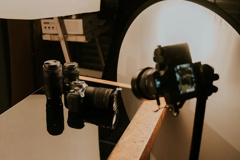 Cameras and lenses on a table in a video production setup for YouTube channels