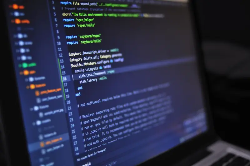 Laptop screen with website code open in an editor