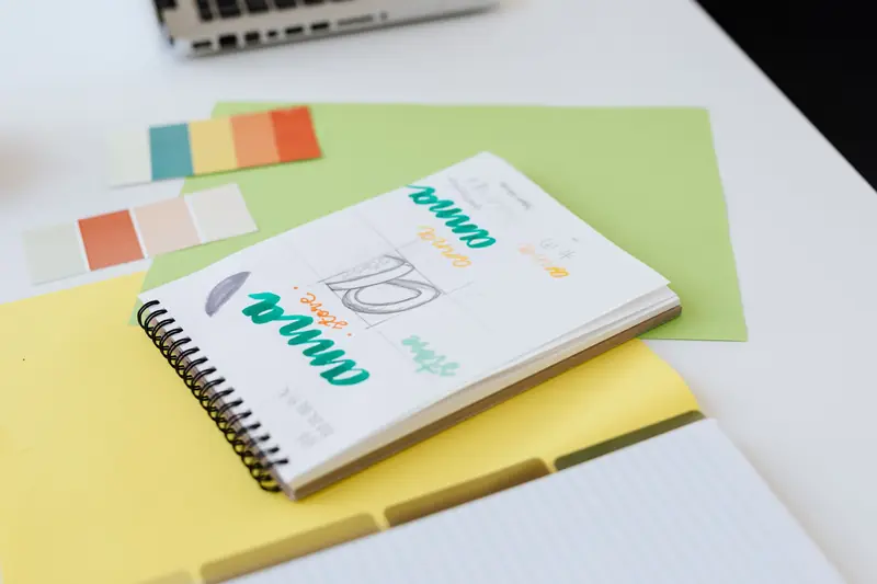 Brand identity sketches and colour palettes in a designer notebook