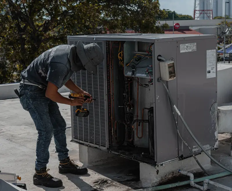 Air conditioning technician working on a rooftop unit