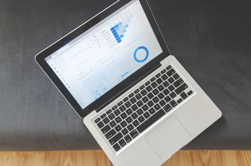 Laptop displaying an SEO analytics dashboard with traffic charts
