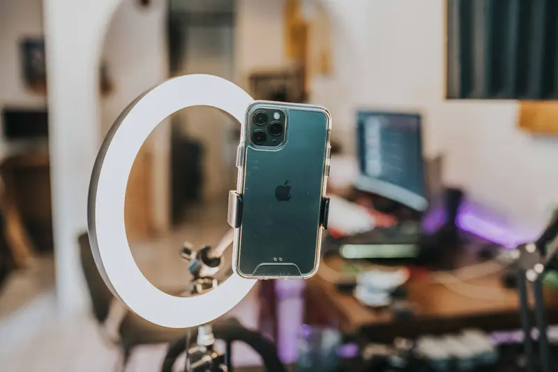 Smartphone mounted in a ring light ready to record a short video