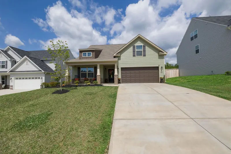 Suburban house with a two-car garage door and driveway
